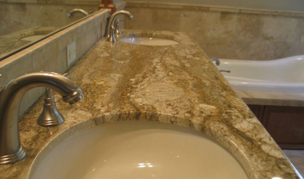 beige bathroom counter with two sinks