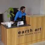 man at front desk at earth art