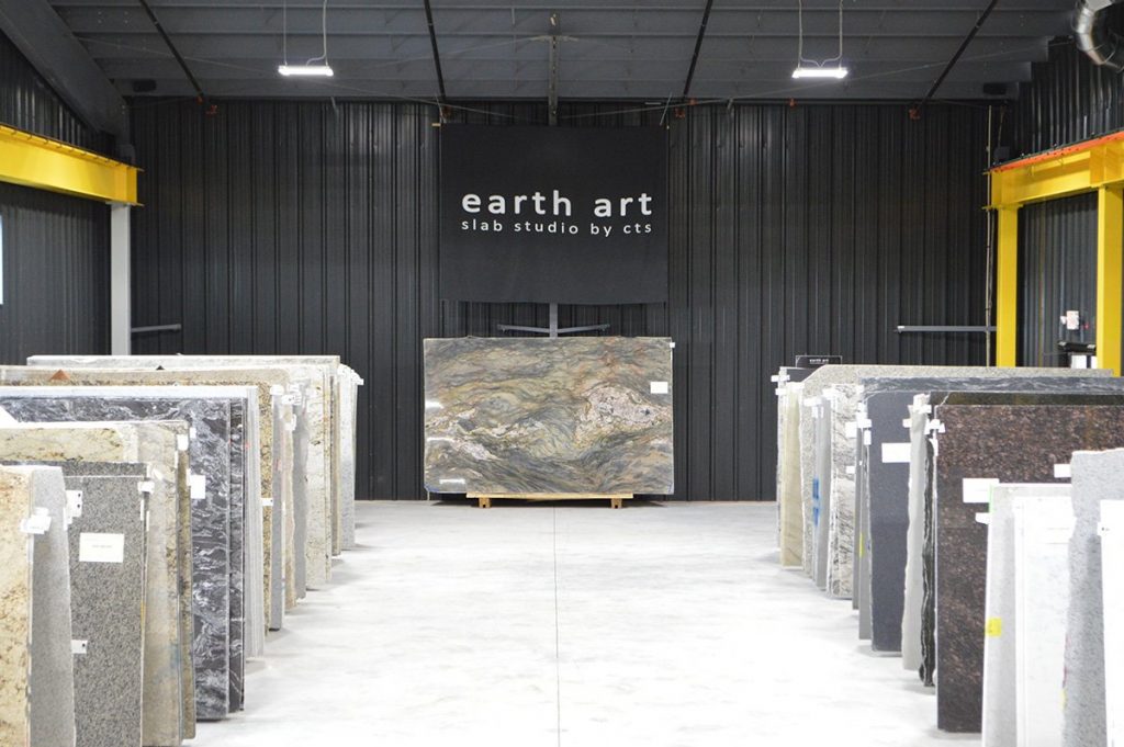 slabs of granite under earth art banner