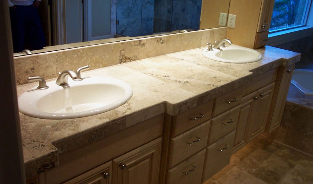 beige bathroom counter with two sinks