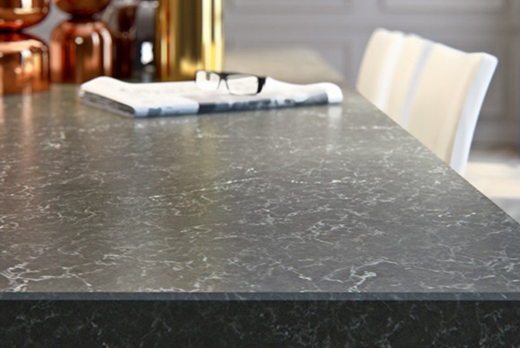 black granite counter with newspaper and glasses