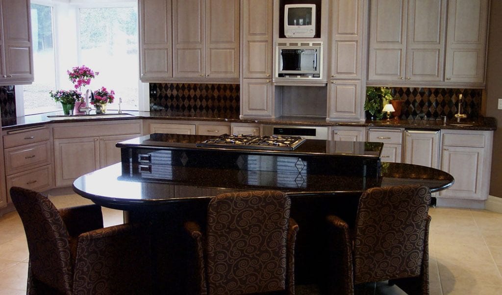 Beautiful cabinets with a black galaxy granite countertop.